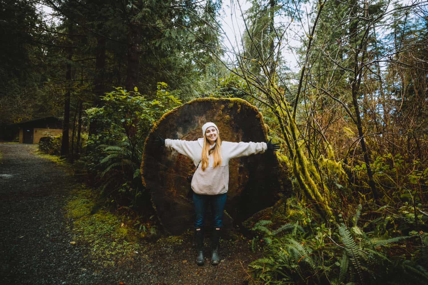 Emily in front of huge tree, Oregon Coast - TheMandagies.com