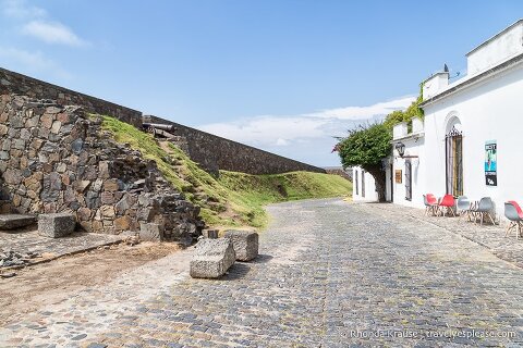 Murallas de la ciudad junto a una calle adoquinada.